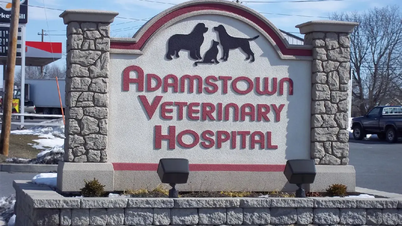Freestanding monument sign with stone columns at a business entrance
